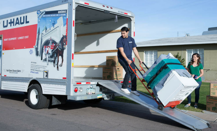 mover helping load washer/dryer onto U-Haul rental moving truck - Edwardsville, IL