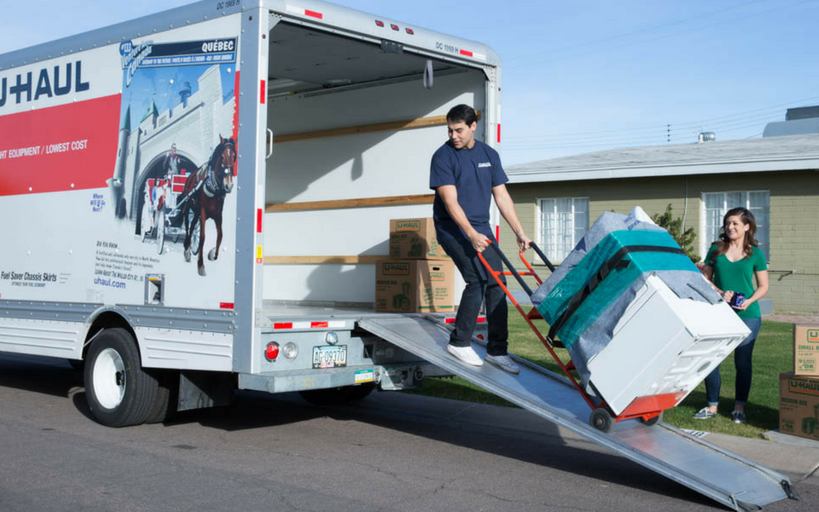 mover helping load washer/dryer onto U-Haul rental moving truck - Troy, IL